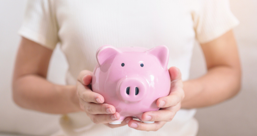 Hands holing piggy bank