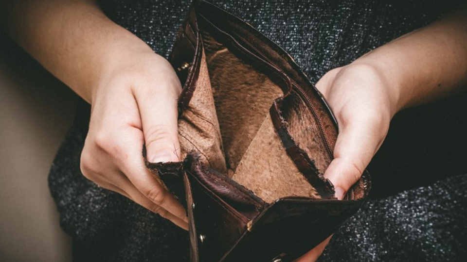 Old empty wallet in the hands .Vintage empty purse in hands of women