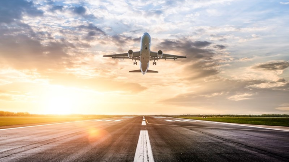 Passenger airplane taking of at sunrise
