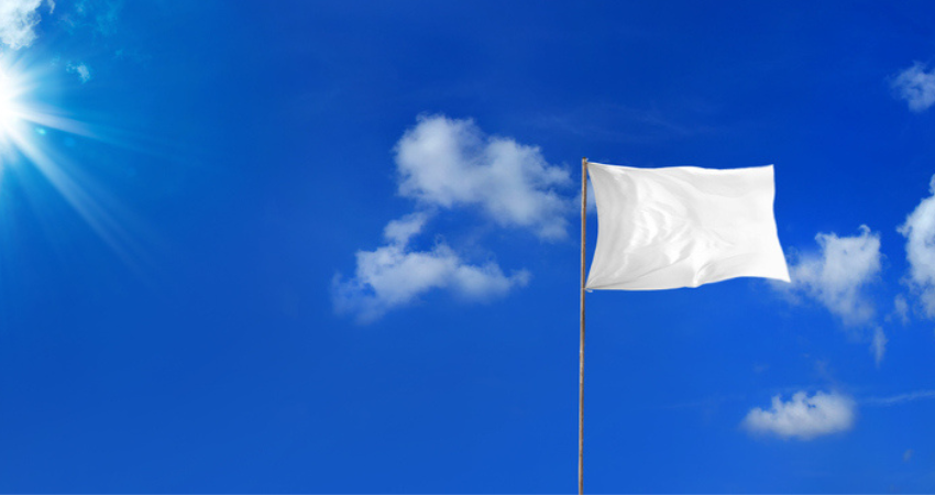 White flag on blue sky background