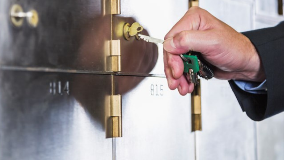 Man unlocking a safety deposit box