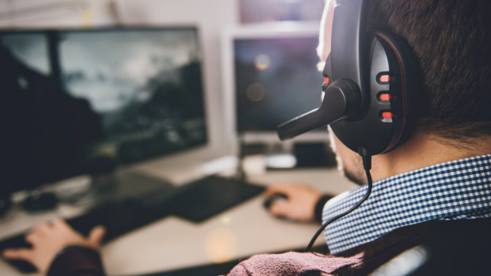 Person with headphone one looking at computer screen