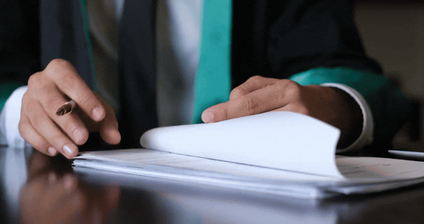 Unknown lawyer checks and signs official documents