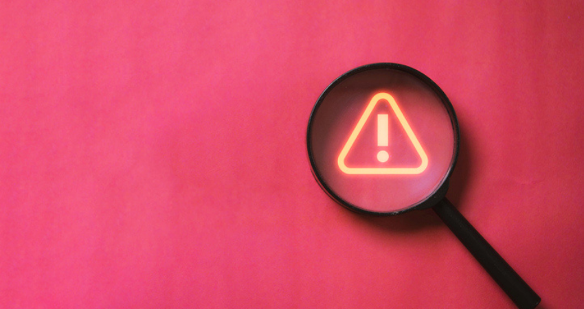Red warning with magnifying glass over the warning sign