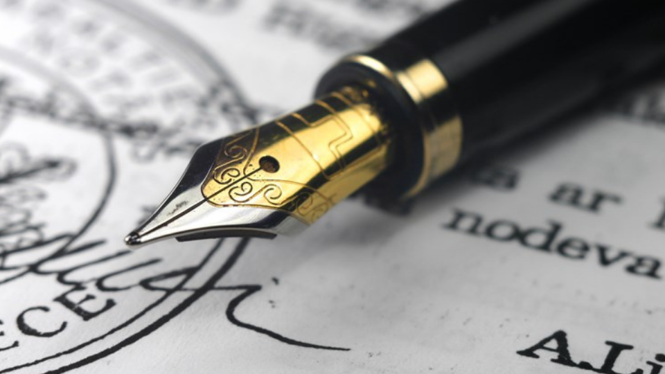 Golden nib pen on document