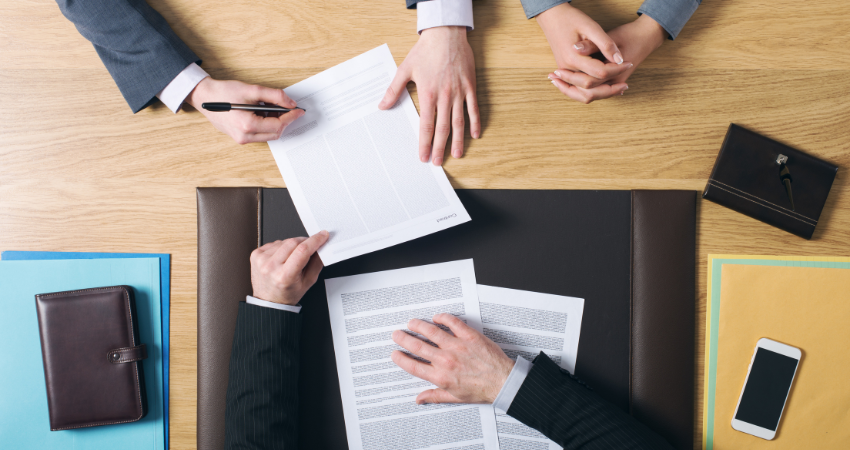 Documents being signed over desk