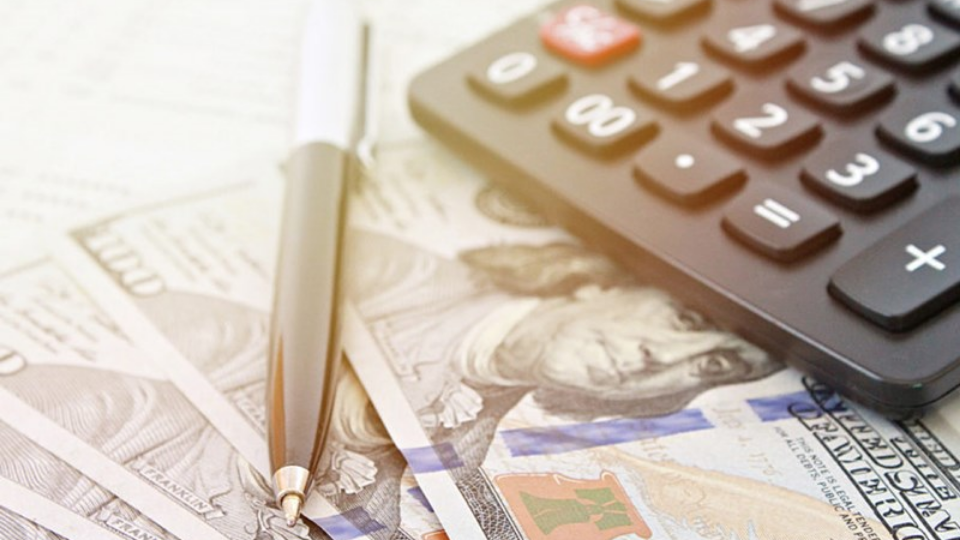 Calculator and pen onto of money