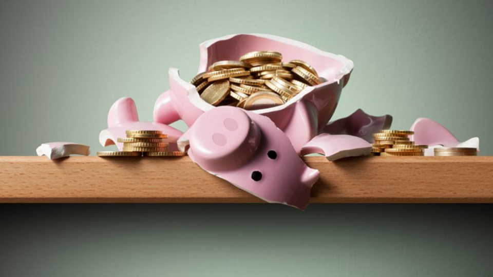 Broken piggy bank with coins