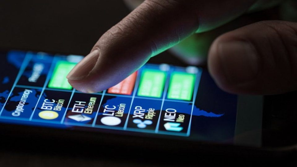 Finger on phone poised over crypto purchase