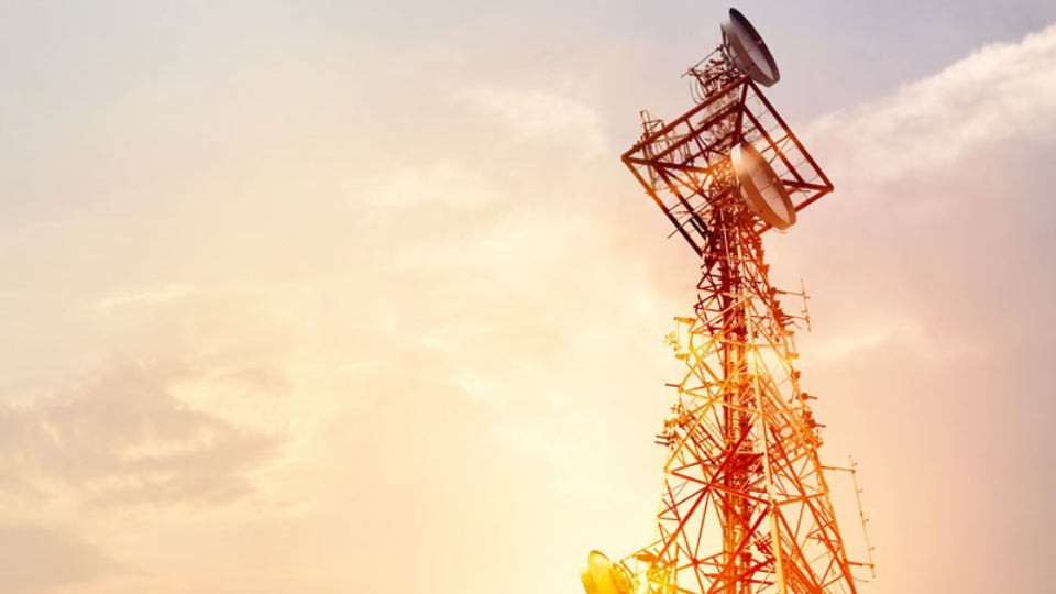 Abstract telecommunication tower Antenna and satellite dish at sunset sky background