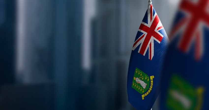 Small flags of British Virgin Islands on a blurry background of the city