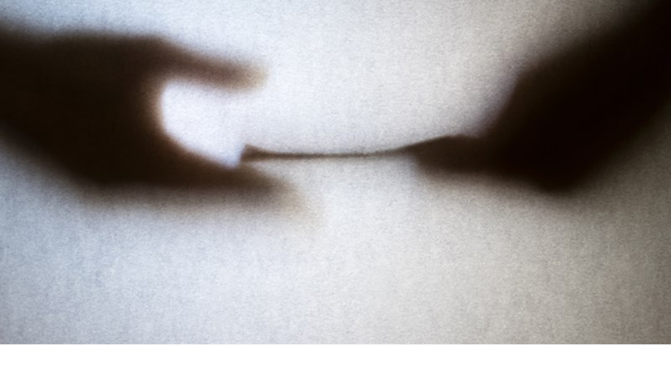 Silhouette of business man hands giving bribe isolated on grey background