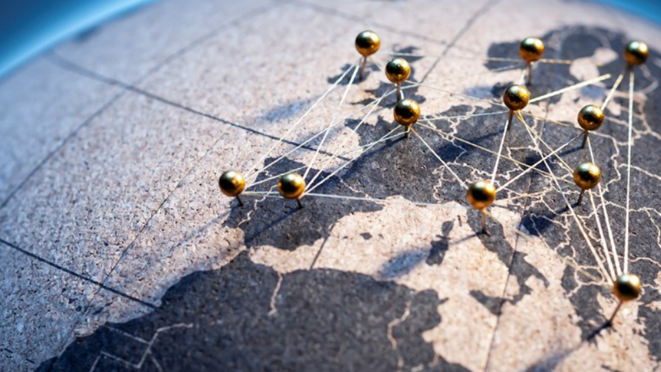 European Connection - Golden pins on cork board globe