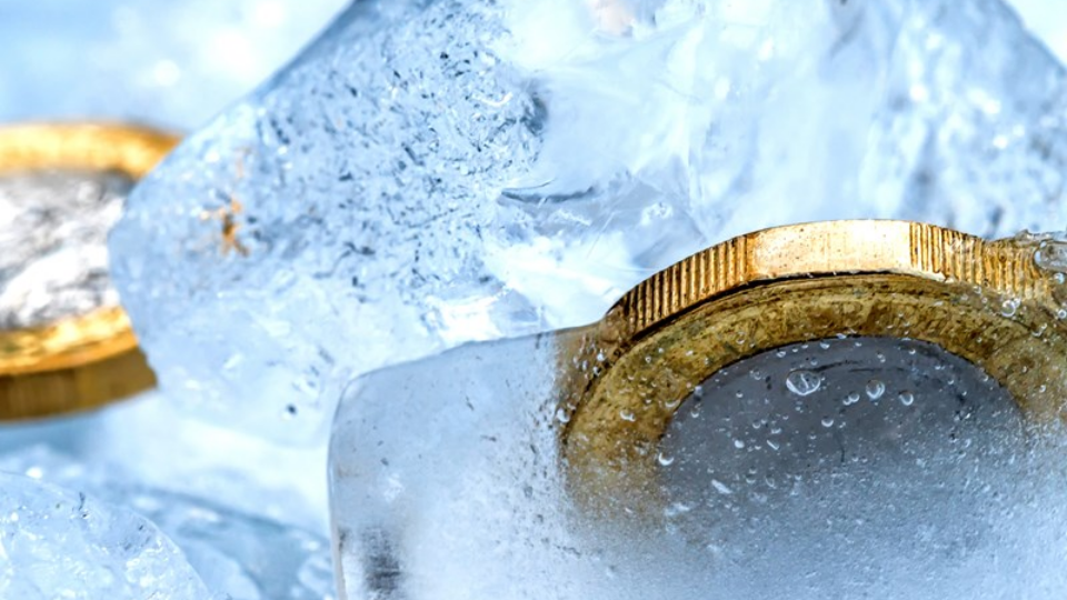 Frozen New British one pound sterling coin up close macro inside ice cubes